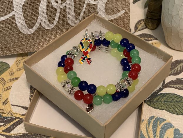 Colorful autism awareness rosary bracelet in gift box